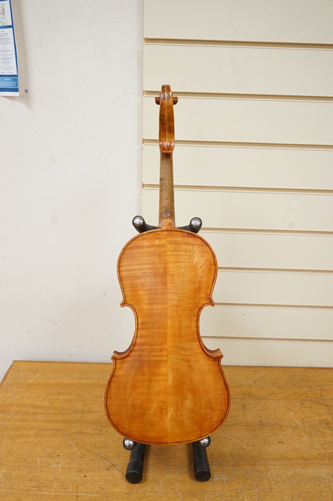 Three violins; a late 19th century German Stradivarius pattern violin, without label, a handmade violin (a.f.), with sound post crack, broken and repaired scroll, etc. and a Maidstone violin body, varnish stripped from t